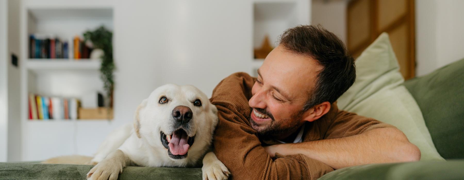 a man lying on a couch with a dog