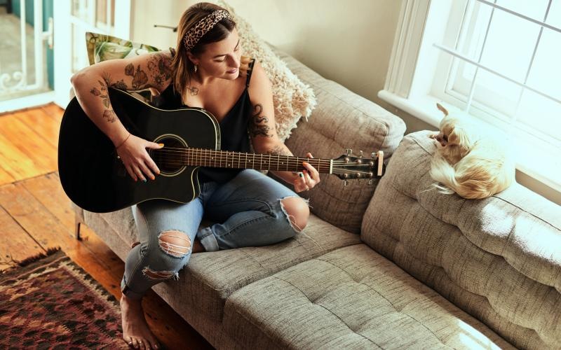 a woman playing a guitar