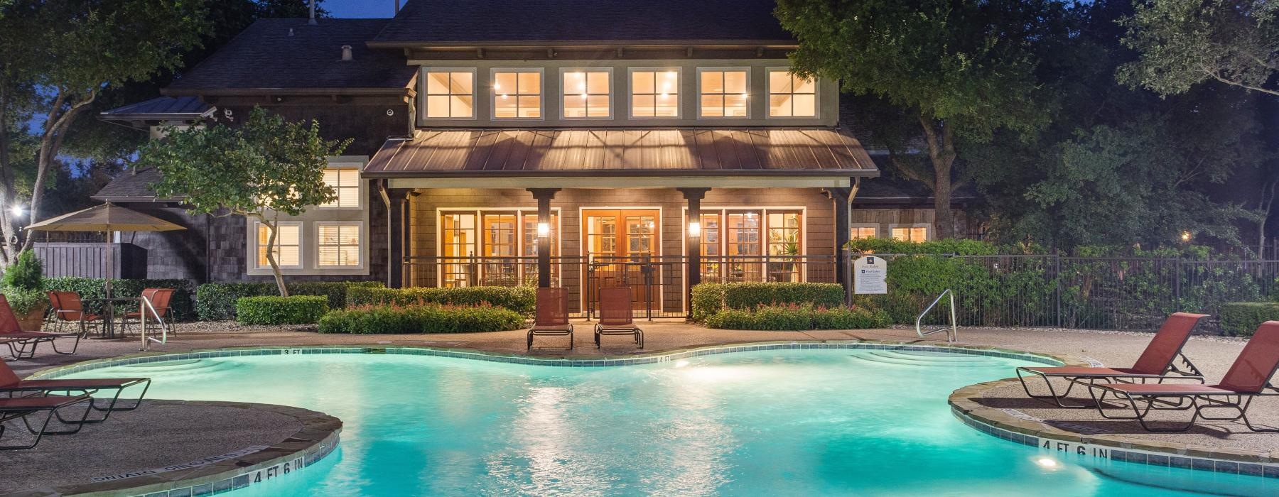 a swimming pool with chairs around it