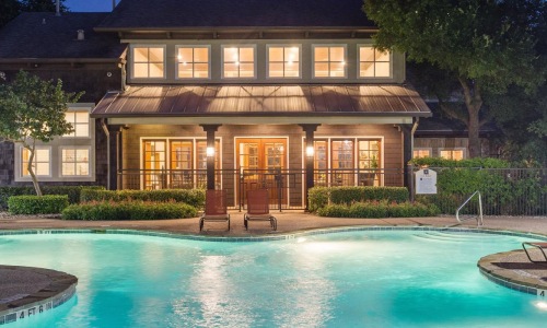 a swimming pool with chairs around it
