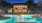 a swimming pool with chairs around it