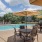 a pool with tables and chairs next to it