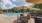 a pool with tables and chairs next to it