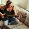 a woman playing a guitar