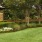 a lawn with a brick building and trees