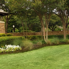 The essence of exceptional living a lawn with a brick building and trees