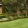 a lawn with a brick building and trees
