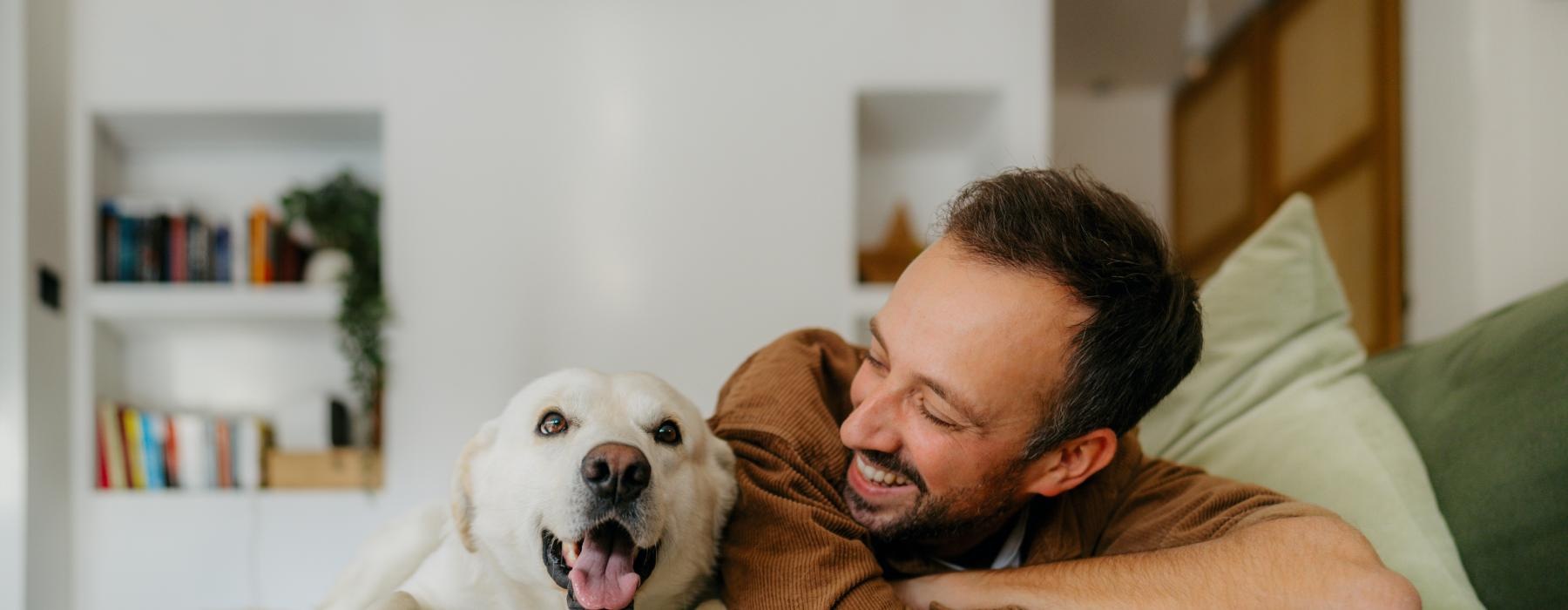a man lying on a couch with a dog