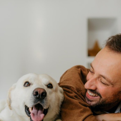 a man lying on a couch with a dog