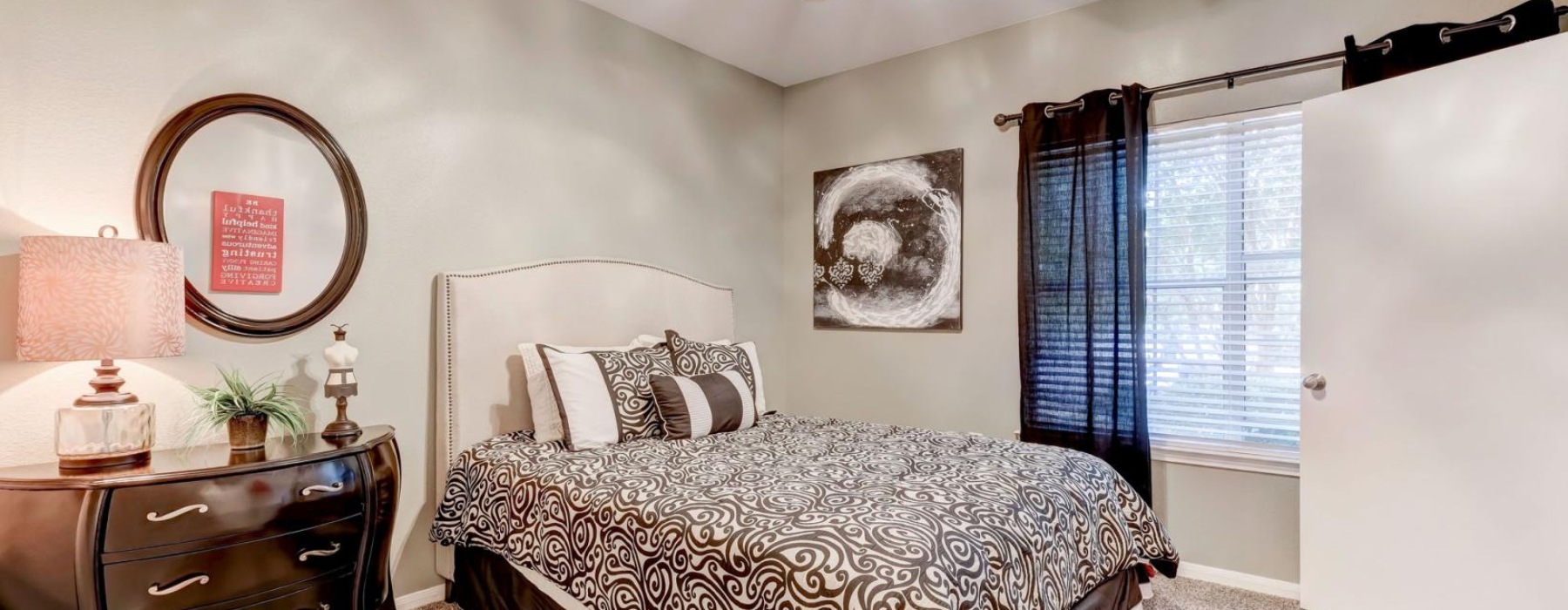 a bedroom with a bed and a mirror