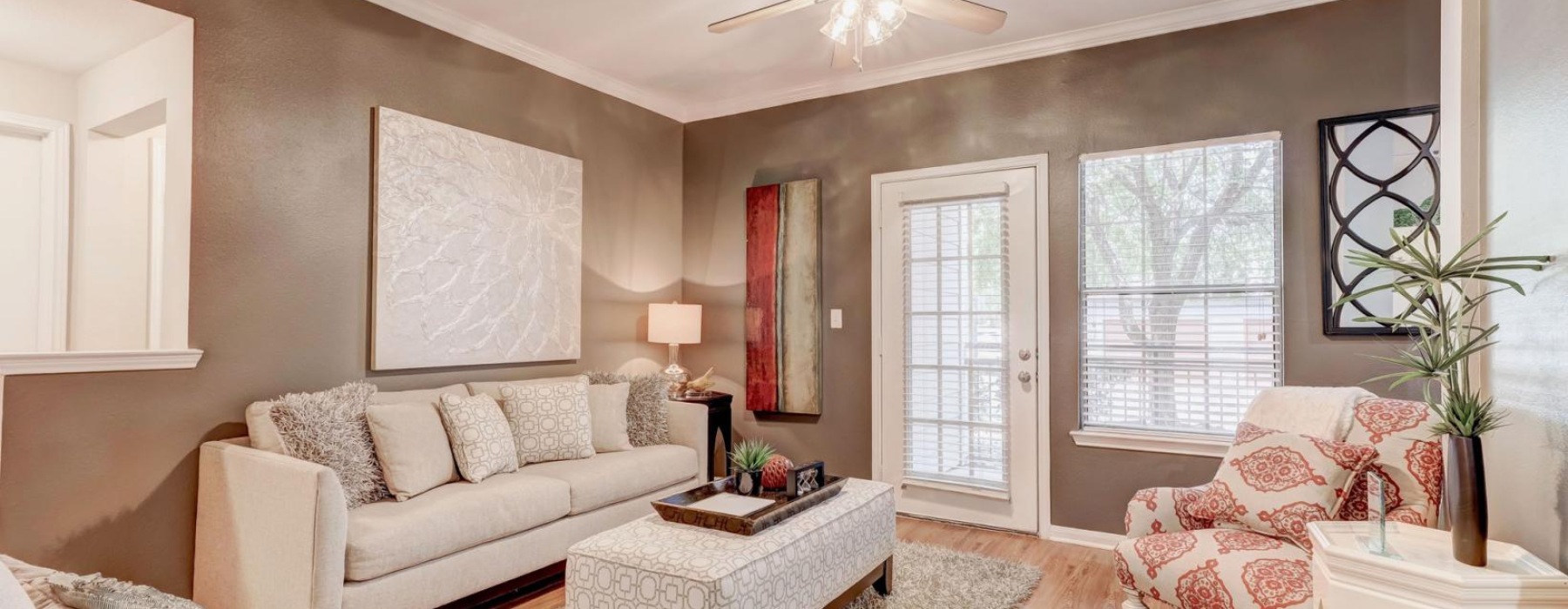 a living room with a white couch and a white table